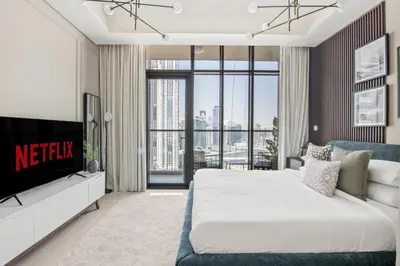 a bedroom with a king sized bed and a tv at GuestReady - Contemporary studio in Business Bay in Dubai