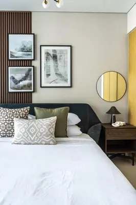 a bedroom with a white bed and a mirror at GuestReady - Contemporary studio in Business Bay in Dubai