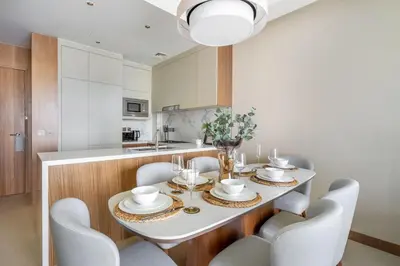 a dining room with a white table and chairs at GuestReady - Glamorous place near Burj Khalifa in Dubai