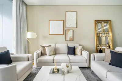 a living room with two couches and a table at GuestReady - Above the clouds in Dubai Marina in Dubai