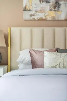 a bedroom with a white bed with pillows at GuestReady - Above the clouds in Dubai Marina in Dubai