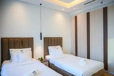 two beds sitting next to each other in a room at Super Luxurious! New 2BR in Jumeirah Garden City in Dubai