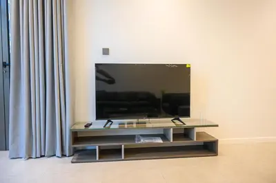 a flat screen tv on a wall in a living room at Super Luxurious! New 2BR in Jumeirah Garden City in Dubai