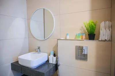 a bathroom with a sink and a mirror at Super Luxurious! New 2BR in Jumeirah Garden City in Dubai