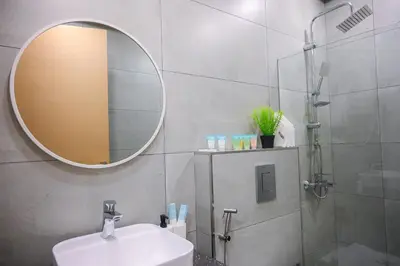 a bathroom with a sink and a mirror at Super Luxurious! New 2BR in Jumeirah Garden City in Dubai