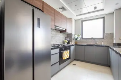 a kitchen with stainless steel appliances and a window at Frank Porter - Eleganz by Danube in Dubai