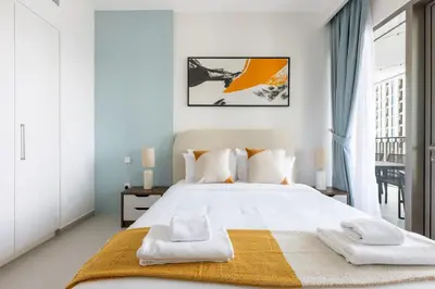 a bedroom with a large white bed with towels on it at Amazing Patio Experience - Best Burj Khalifa View in Dubai