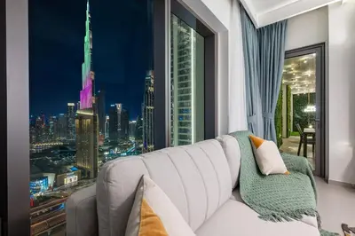 a living room with a large window with a view of a city at Amazing Patio Experience - Best Burj Khalifa View in Dubai
