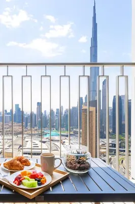a table with two plates of food and a view of the city at Amazing Patio Experience - Best Burj Khalifa View in Dubai