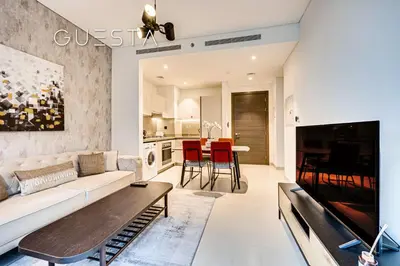 a living room with a white couch and a tv at Sobha Creek Vistas, Sobha Hartland, MBR City, Dubai in Dubai
