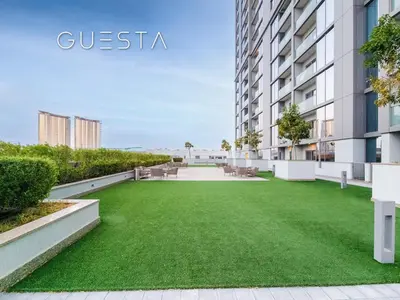an apartment with a green lawn in front of a building at Sobha Creek Vistas, Sobha Hartland, MBR City, Dubai in Dubai