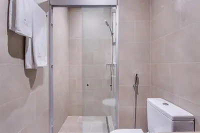 a bathroom with a shower and a toilet at STAY BY LATINEM Luxury 1BR Holiday Home CV A1507 near Burj Khalifa in Dubai