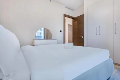 two white beds in a room with a mirror at STAY BY LATINEM Luxury 1BR Holiday Home CV A1507 near Burj Khalifa in Dubai