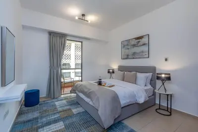 a bedroom with a large bed and a window at Amazing Seaview Prime Location Upgraded in Dubai
