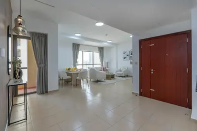 a living room with a kitchen and a dining room at Amazing Seaview Prime Location Upgraded in Dubai