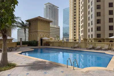 a large swimming pool in a city with tall buildings at Amazing Seaview Prime Location Upgraded in Dubai