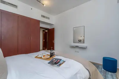 a bedroom with a bed with a tray of food on it at Amazing Seaview Prime Location Upgraded in Dubai