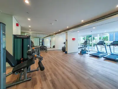 a gym with treadmills and machines in a room at 1BR near Dubai Mall 10 Min walking distance in Dubai