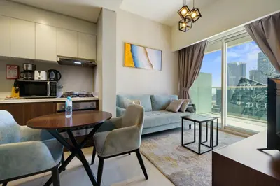 a living room with a couch and a table at 1BR near Dubai Mall 10 Min walking distance in Dubai