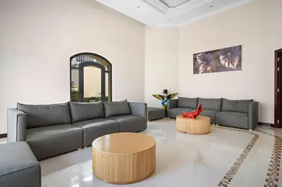 a living room with a couch and a table at Beachfront Dubai Villa for 10 Guests with Full Kitchen & View in Dubai