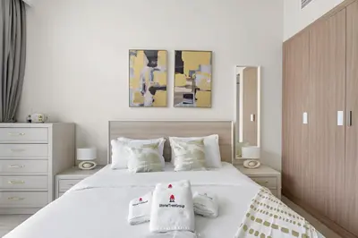a bedroom with a white bed with two pillows on it at StoneTree - Azizi Riviera 36 Studio - Brand new in Dubai