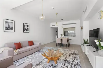 a living room with a couch and a table at Stonetree - Golden Mile 4 - Beach Access in Dubai