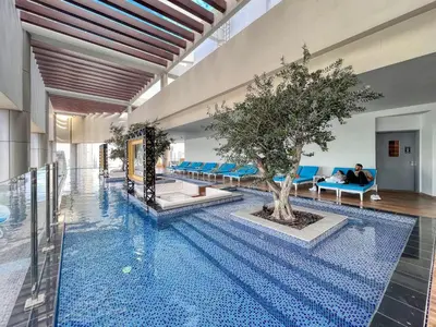 a pool with a tree in the middle of a building at Highest infinity Pool in Downtown Dubai in Dubai
