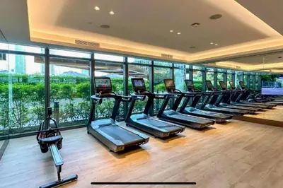 a gym with a row of cardio machines in a building at Luxury of 1 minute walk to Burj Khalifa & D/Opera in Dubai
