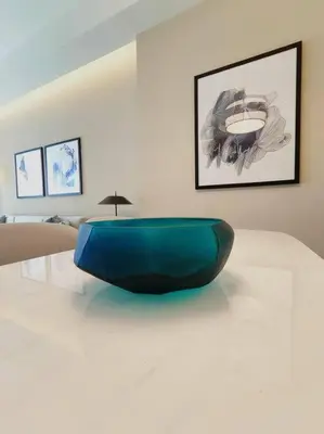 a blue bowl sitting on a table in a room at Luxury of 1 minute walk to Burj Khalifa & D/Opera in Dubai