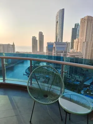 a balcony with a chair and a view of a city at Waterfront Marina Best View Amazing Location 2 Bed in Dubai