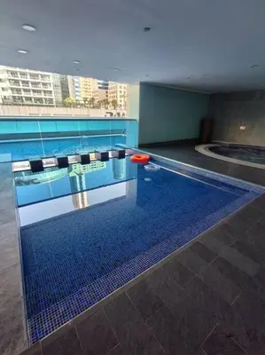 a swimming pool with a red frisbee in it at Waterfront Marina Best View Amazing Location 2 Bed in Dubai