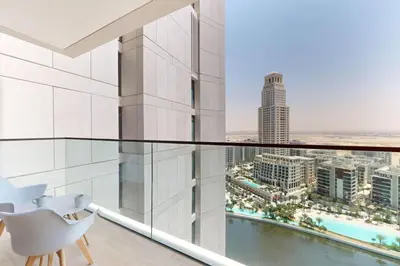 a glass balcony with a view of the city at Palace Residences - Modern One Bedroom in Dubai