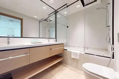 a bathroom with a sink and a shower and a toilet at Palace Residences - Modern One Bedroom in Dubai