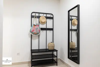 a mirror and a table with a hat on it at Al Andalus D I Jumeirah Golf Estates in Dubai