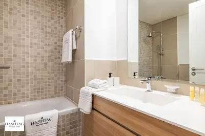 a bathroom with a sink and a mirror at Al Andalus D I Jumeirah Golf Estates in Dubai