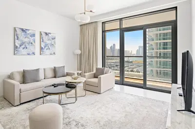 a living room with white furniture and a large window at Silkhaus Chic 1BDR in Exclusive Neighbourhood in Dubai