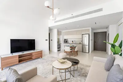 a living room with a couch and a tv at Silkhaus Chic 1BDR in Exclusive Neighbourhood in Dubai