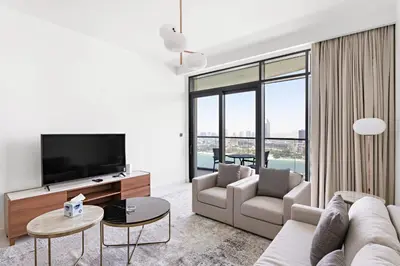 a living room with a couch and a tv at Silkhaus Skyline View | Exclusive Neighbourhood in Dubai