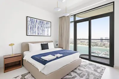 a bedroom with a large bed and a large window at Silkhaus Skyline View | Exclusive Neighbourhood in Dubai