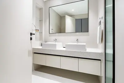 a bathroom with two sinks and a mirror at Silkhaus Skyline View | Exclusive Neighbourhood in Dubai