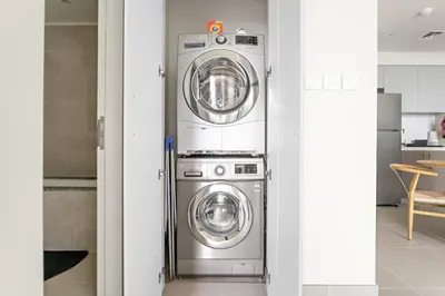 two washer and dryer machines in a room at Silkhaus Chic 1 BDR In a New Tower In Downtown in Dubai