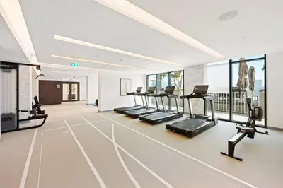 a gym with a row of treadmills and ellipticals at Silkhaus Partial Marina View 1BDR in Marina Vista in Dubai