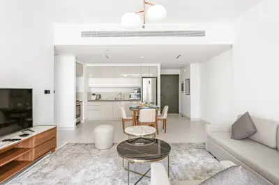 a living room with a couch and a table at Silkhaus Partial Marina View 1BDR in Marina Vista in Dubai