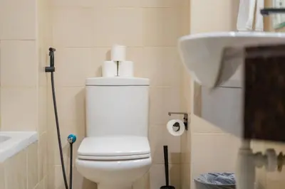 a bathroom with a white toilet and a sink at Luxury Studio - Golf Views - Sports City Dubai in Dubai