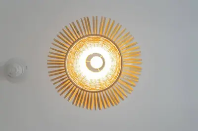 a ceiling light in a room with at Luxury Studio - Golf Views - Sports City Dubai in Dubai