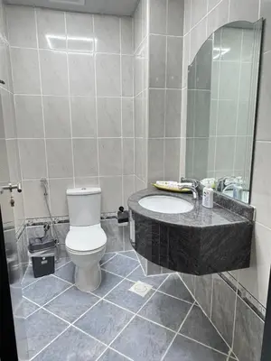a bathroom with a toilet and a sink and a mirror at Stay in brand new Luxury Sport City apartment 15 in Dubai