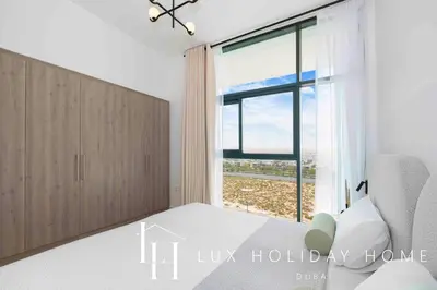 a bedroom with a bed and a large window at LUX The Dubai Hills Executive Suite in Dubai