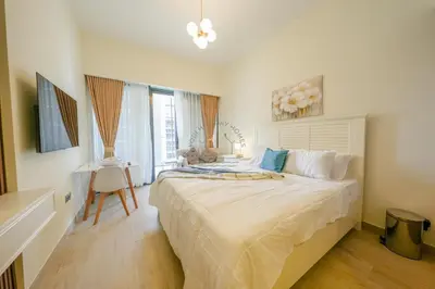 a bedroom with a large bed and a window at Azizi Riviera 18 in Dubai