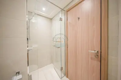 a bathroom with a shower and a glass door at Azizi Riviera 18 in Dubai