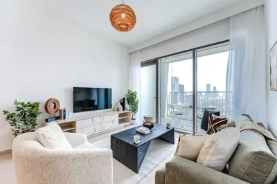 a living room with a couch and a tv at Silkhaus High Floor 1 BDR In The Heart of Downtown in Dubai
